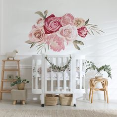 a white crib with flowers painted on the wall