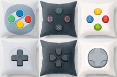 four pillows with different buttons on them in the shape of video game controllers, one for nintendo wii