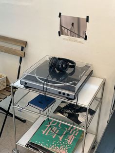 a record player sitting on top of a table next to a chair and other items