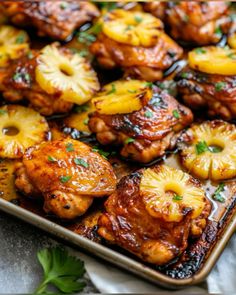 chicken with pineapples and onions on a baking sheet, ready to be served