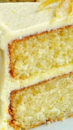 a slice of cake with white frosting and oranges on top sits on a plate