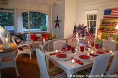 a dining room table set with red, white and blue place settings for fourth of july