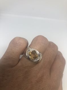 Unusual cut of citrine surrounded by white sapphires Sterling Filigree gold finished Setting Handmade Size 7 Can be resized, my jeweler charges a $10 fee All rings are shipped in a nice gift box. Check out our over a THOUSAND great reviews Engraving is $4 per letter and is not always perfect depending on the piece. It can take a few days if the jeweler is busy. This is payable to Paypal Judithsltd@gmail.com Citrine Ring With Accent Stones, Unique Citrine Rings With Accent Stones, Citrine Jewelry Stamped 925, Gold Topaz Ring Stamped 925 For Anniversary, Handmade Gold Topaz Ring In Sterling Silver, Citrine Crystal Ring With Accent Stones As Gift, Unique Citrine Rings For Anniversary, Handmade Citrine Crystal Ring For Anniversary, Unique Citrine Jewelry For Anniversary