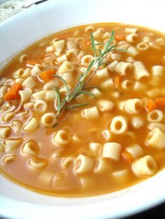 a white bowl filled with macaroni and cheese soup