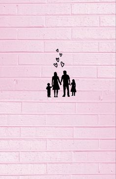 a pink brick wall with an image of a man and woman holding hands while standing in front of a child's hand