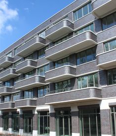 an apartment building with many balconies and windows