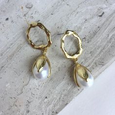 This Pair Of Elegant Golden Hoop And Pearl Earrings Have A Clean & Classic Look. A Slightly Irregular Gold Circle, With A Post Back, Has Small Waves And Grooves Which Catch Lots Of Light. It Sits On The Bottom Of The Ear Lobe With Its Post Back. The Tulip Shaped Pearl Is Free To Sway Below And Has A Beautiful Iridescent Sheen. Gold Plated, Faux Pearl, Ear Backs Included. Approx. Size: 1-1/2" L, 5/8"W Brand New Item, Handmade Jewelry By: Jpeace Designs Everyday Earrings, Classy, Trendy White Metal Teardrop Earrings, White Metal Teardrop Earrings With Pearl Drop, White Teardrop Pearl Earrings, Modern White Teardrop Hoop Earrings, Chic White Teardrop Hoop Earrings, Spider Earrings, Bamboo Earrings, Beaded Tassel Earrings, Heart Shaped Earrings