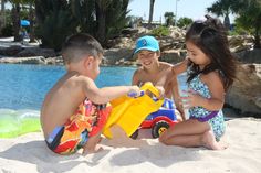 two children playing with toys on the beach