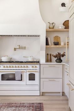 a white stove top oven sitting inside of a kitchen