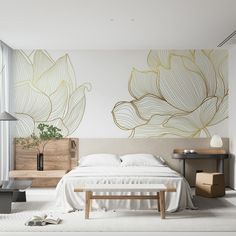 a white bed sitting in a bedroom next to a wooden table and lamp on top of a hard wood floor