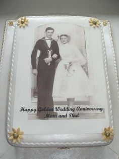 a wedding cake is decorated with an image of two people in formal dress and gold flowers