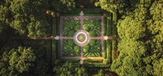 an aerial view of a garden surrounded by trees