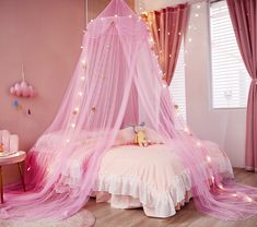 a pink bedroom decorated with fairy lights