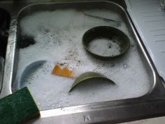 a metal sink filled with lots of white foam