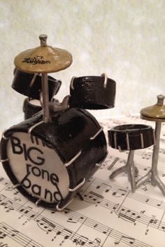 a toy drum set sitting on top of sheet music