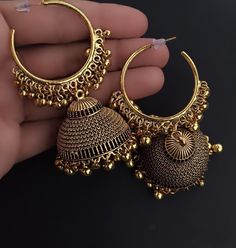 Antique golden jhumkas are traditional Indian earrings over 100 years old, crafted from gold-plated brass or other alloys. Available in four designs .These earrings reflect historical Mughal or South Indian styles Intricate Design Jhumkas For Festival Gifts, Intricate Design Jhumkas As Festival Gift, Gift Brass Jhumkas With Latkans, Gift Jhumkas With Intricate Design For Festivals, Festive Bohemian Jhumkas, Festival Brass Jhumkas For Celebrations, Brass Jhumkas For Festivals And Celebrations, Diwali Brass Jhumkas With Latkans, Round Brass Jhumkas As Gift