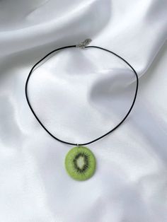 How about some sassy kiwi slice bling? Add some fruity fun to your wardrobe with this one-of-a-kind kiwi slice ornament necklace - the perfect pick-me-up gift for your fruit-loving friend! Include : 1 pair of earrings ○ Lenght  : 19.5'' (with hook) 1.35"x 1.25"(the kiwi ) ○ Color: green ○ Materials :  necklace, chain,  sublimation ink,felt fabric, glue ○ Design and made in Latvia ♥ If you need any costumized items, please contact me. The color can be little different from the photo, because of t Handmade Green Novelty Necklace, Trendy Green Jewelry With Fruit Design, Cute Green Jewelry With Fruit Design, Trendy Lime Green Jewelry For Gift, Trendy Lime Green Jewelry Gift, Trendy Lime Green Jewelry As A Gift, Novelty Green Necklace For Gifts, Green Novelty Necklace For Gift, Unique Green Necklace For Gift