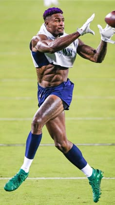 a man catching a football on top of a field