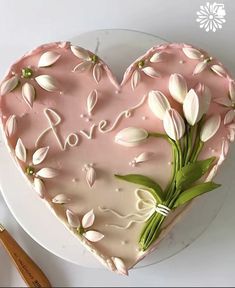 a heart shaped cake with flowers on it