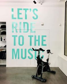 there is a bike that is in the room and it says let's ride to the music