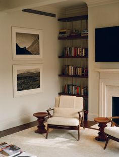 a living room filled with furniture and a flat screen tv mounted on the wall above a fireplace