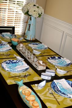 the table is set with blue and white dishes