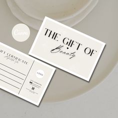 two business cards sitting on top of a white plate