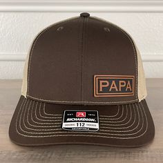 PAPA side leather patch hat Brown/Khaki. Specifications: 🧢 Richardson original 112 trucker; adjustable for the perfect fit 🎩 60/40 cotton/polyester blend for comfort 📏 One size fits most 🏷️ Expertly laser engraved leatherette patch design 📦 Ships in 2 to 3 business days from our Orlando Studio Care Instructions: 🚫 Do not wash; spot clean only Please Note: 🌈 Colors may vary from photos based on your viewing screen. Orlando Studios, Leather Patch Hat, Patch Hat, Patch Design, Leather Patches, Laser Engraved, Laser Engraving, Orlando, Trucker Hat