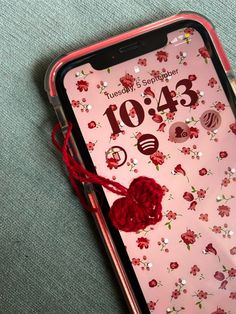 an iphone with a red heart on it and the number 10 / 3 is displayed