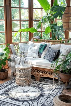 a living room filled with lots of plants and wicker furniture on top of a rug