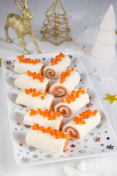 some food is sitting on a white plate with orange sprinkles around it