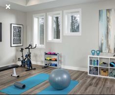 a home gym with exercise equipment and yoga mats