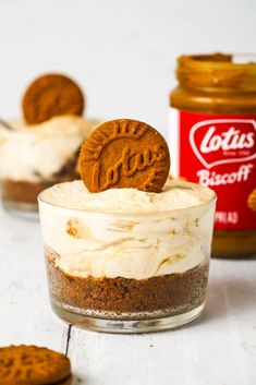 an oreo cookie sitting on top of a dessert in a glass bowl next to two cookies