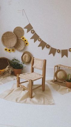 a room with sunflowers and baskets on the wall next to a wooden chair