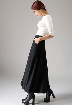 "Look elegant and stylish at all times and for any occasion in this long black classical A-line skirt. This flared women skirt with double stitching detail at hip pockets oozes understated sophistication. This very versatile winter skirt can be worn casually with knitwear or more formally with a crisp white blouse.This is a timeless investment piece you'll have in your wardrobe for years to come. Choosing black makes it so easy to pair with a variety of blouses and jackets. Scientific studies ha Classic A-line Maxi Skirt For Formal Occasions, Elegant A-line Bottoms For Winter, Classic Black A-line Skirt, Black A-line Maxi Skirt For Winter, Elegant A-line Maxi Skirt For Work, Spring Formal Wool Skirt, Formal Wool Skirt For Spring, Formal Spring Wool Skirt, Black Relaxed Classic Maxi Skirt