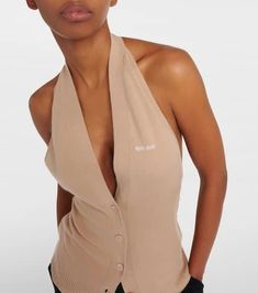 Material: 100% cashmere.Care instructions: dry clean.Made in Italy.Designer color name: Albino.Closure: buttoned front.True to size.Low back.Fitted.Stretchy fabric.Falls to the hip.The model seen in the picture is 178cm-5'10' and wearing a size IT 40 Miu Miu Casual Tops For Workwear, Miu Miu Tops For Spring Workwear, Casual Miu Miu Tops For Spring, Fitted Cashmere Top With Buttons, Fitted Cashmere Tops With Button Closure, Fitted Sleeveless Sweater Vest With Button Closure, Sleeveless Cashmere Tops For Work, Chic Fitted Beige Sweater Vest, Fitted Cashmere Sleeveless Vest