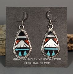 These gorgeous earrings are made by Zuni artists Leslie and Glady's Lamy. All the stone, shell and coral pieces were hand shaped and pieced together then set into a hand made sterling silver settings. Many years of experience and a LOT of time went into these. Leslie and Glady's specialize in these mosaic inlay pieces. You don't see many earrings. They mostly make pendants, bolos and rings. Signed and stamped sterling on the back of each earring. These are approx. 1-13/16" long including the ear wire and 11/16" wide Artisan Teardrop Earrings With Artistic Design, Elegant Drop Earrings With Inlay, Sterling Silver Teardrop Jewelry With Artistic Design, Handmade Southwestern Oval Earrings, Artisan Jewelry With Matching Earrings For Collectors, Artisan Teardrop Jewelry For Collectors, Sterling Silver Multi-stone Teardrop Earrings, Artisan Collectible Jewelry With Matching Earrings, Unique Oval Inlay Jewelry