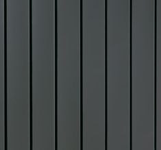 a black and white photo of the side of a building with vertical lines painted on it