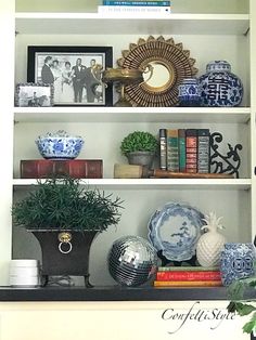 a book shelf filled with books and vases