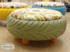 three colorful foot stools sitting on top of a wooden floor next to each other