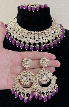 It is a beautiful necklace set for women. It is studded with Dabi kundan and purple moti. It comes with chandbali style earrings and mang tikka. Color purple. No return or exchange please. Very lightweight earrings. Indian Jewelry Purple, Purple Indian Earrings, Purple Bridal Jewelry Sets, Indian Wedding Jewellery Bridal Jewelry, Purple Kundan Jewellery, Purple Earrings Indian, Purple Jewellery Set, Purple Jewelry Necklace, Purple Necklace Set