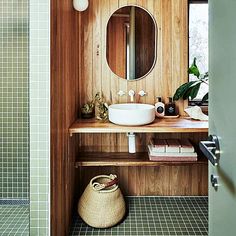 a bathroom with a sink and mirror in the corner next to a tiled flooring area