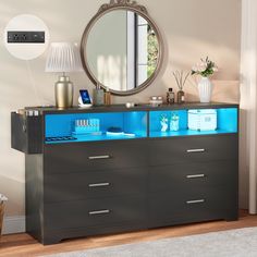 a modern dresser with blue drawers and mirror