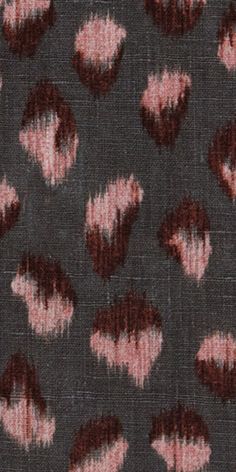 an animal print fabric with pink and black spots