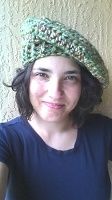 a woman wearing a crocheted hat with the words, the shewood forest beret