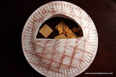 a paper plate with some crackers in it