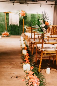 an aisle with flowers and candles on it