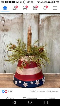 a red, white and blue patriotic hat with a candle in it sitting on a wooden table