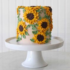 a white cake with sunflowers on it