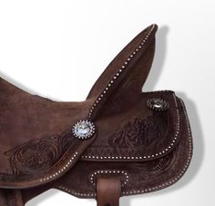 a close up of a brown leather saddle with studded decorations on the inside and outside